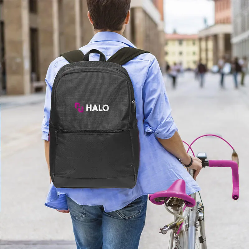 Man walking with bike wearing HALO branded backpack
