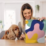 Woman with dog opening Branded Merchandise Kit from HALO