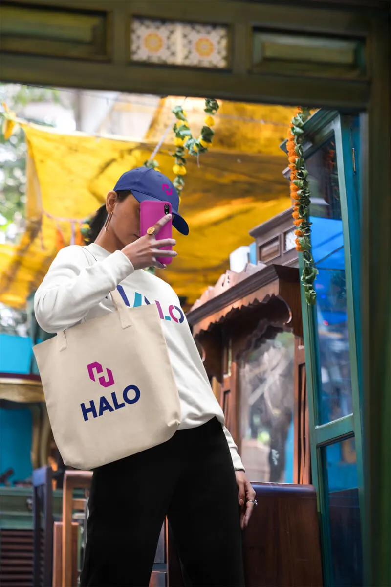 Woman taking selfie with HALO bag and hat